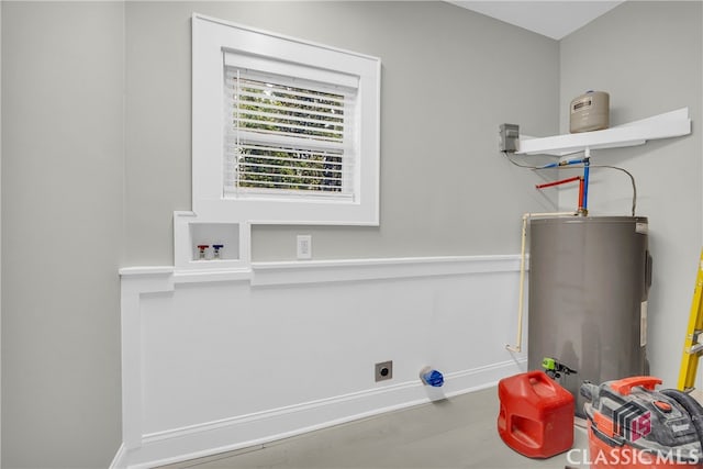 washroom with electric water heater, laundry area, electric dryer hookup, and baseboards