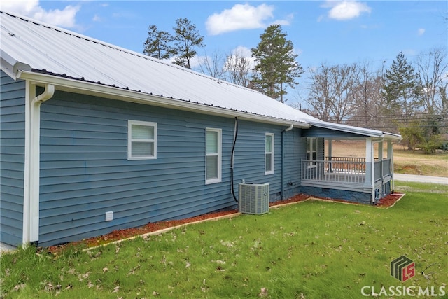 view of property exterior featuring central AC, a yard, crawl space, and metal roof