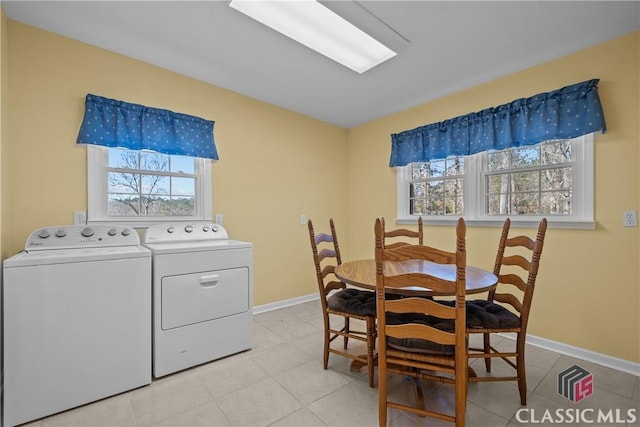 laundry room with baseboards, laundry area, plenty of natural light, and washer and dryer