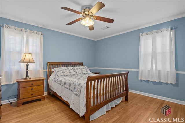 bedroom featuring light wood-style floors, baseboards, and visible vents