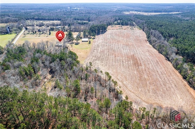 birds eye view of property with a forest view