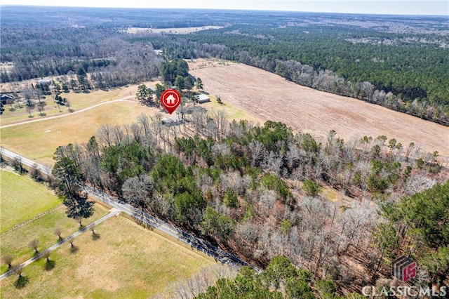 bird's eye view with a rural view and a wooded view