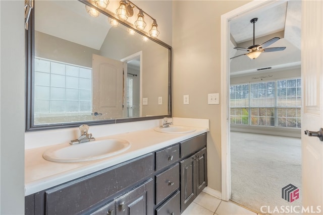 bathroom with ceiling fan, double vanity, a sink, and tile patterned floors