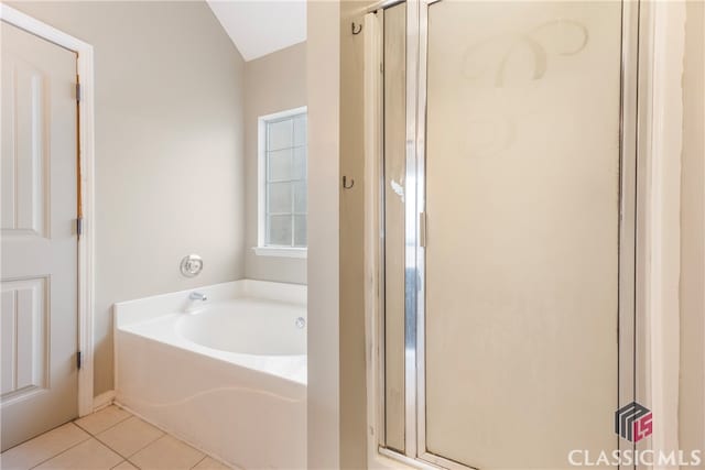 full bathroom with a garden tub, tile patterned flooring, and a shower stall