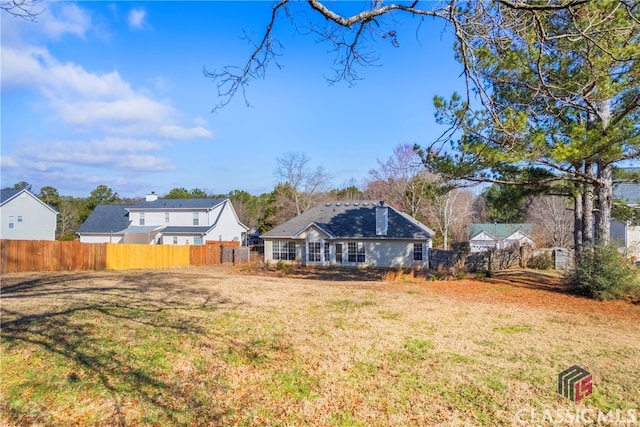 view of yard featuring a residential view and fence