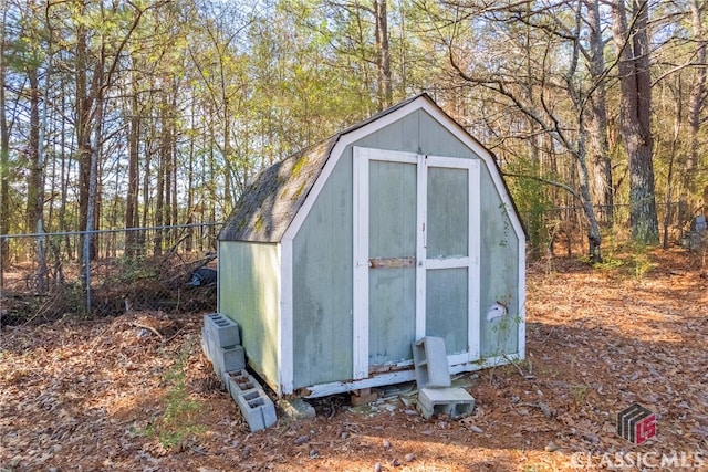 view of shed with fence