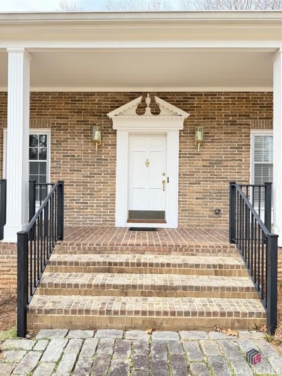 property entrance with brick siding