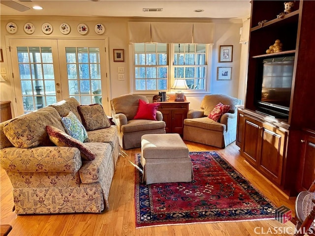 living room featuring visible vents, wood finished floors, and french doors