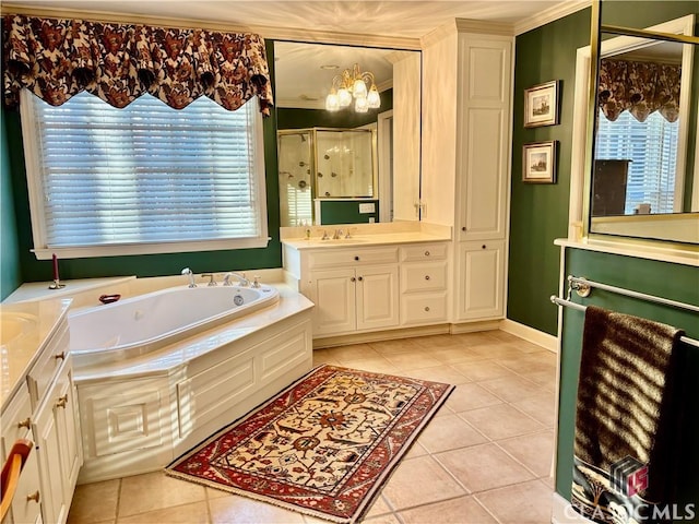 bathroom with a stall shower, a garden tub, vanity, and tile patterned floors