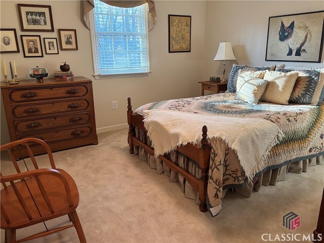 bedroom with baseboards and light colored carpet