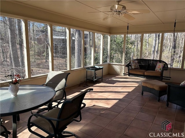 sunroom / solarium with a healthy amount of sunlight and a ceiling fan