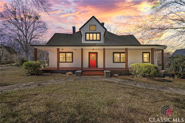 view of front of home featuring a porch and a yard