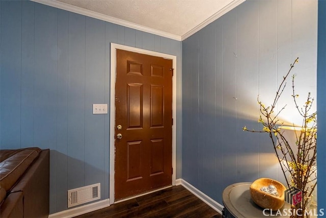 entrance foyer with dark wood-style floors, visible vents, ornamental molding, a textured ceiling, and baseboards