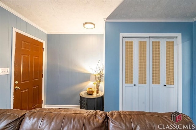 interior space with a textured ceiling and crown molding