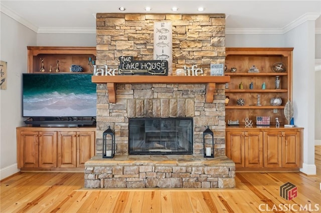 living area with a fireplace, light wood-style flooring, and crown molding