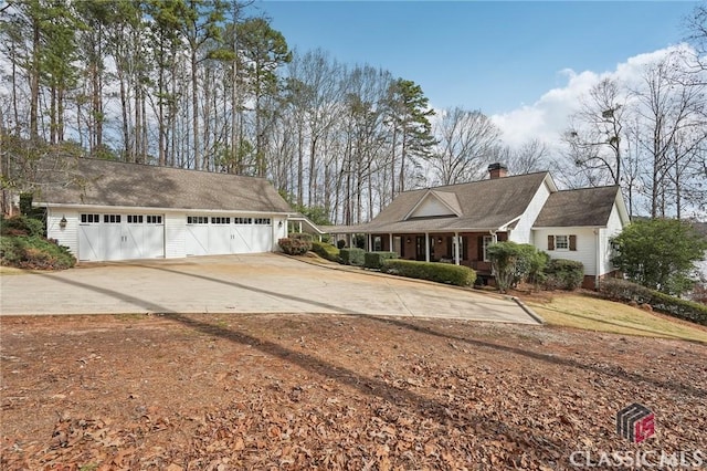 view of front of property with a garage and a chimney