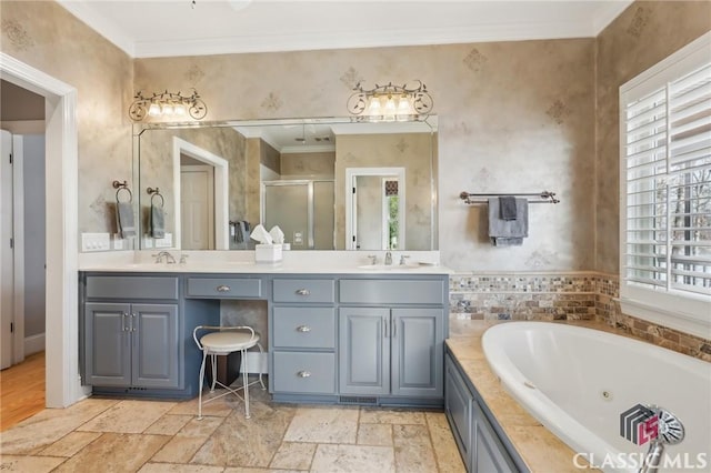 bathroom featuring a sink, double vanity, a stall shower, stone tile flooring, and crown molding