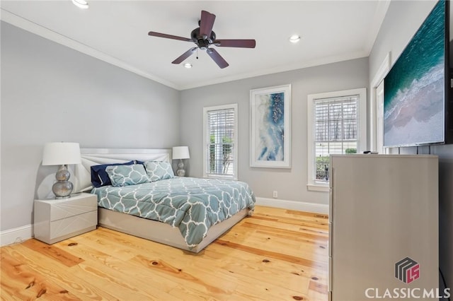 bedroom featuring ornamental molding, baseboards, and wood finished floors