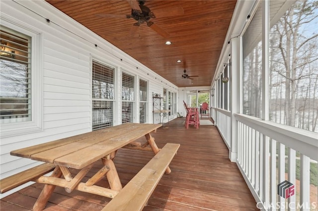 sunroom with a ceiling fan and wooden ceiling