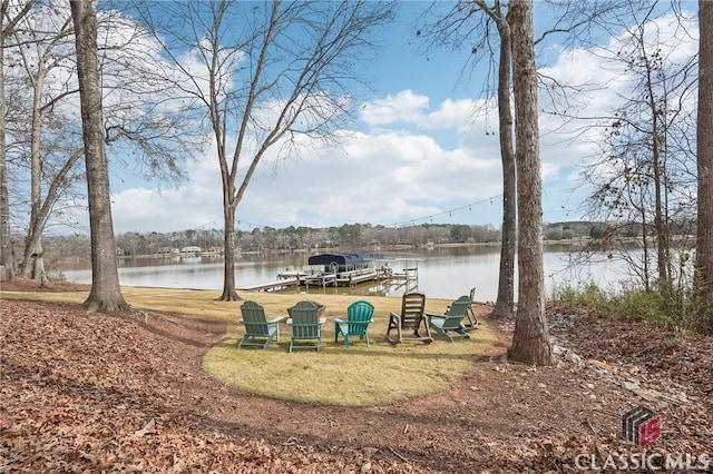 view of yard featuring a water view and a dock