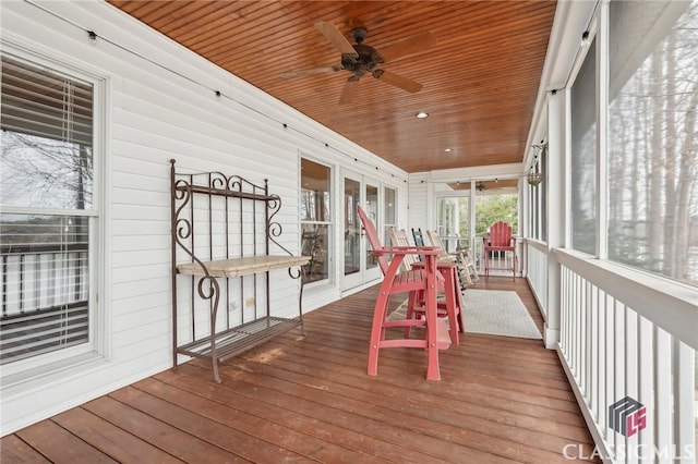 wooden deck featuring a ceiling fan and a porch