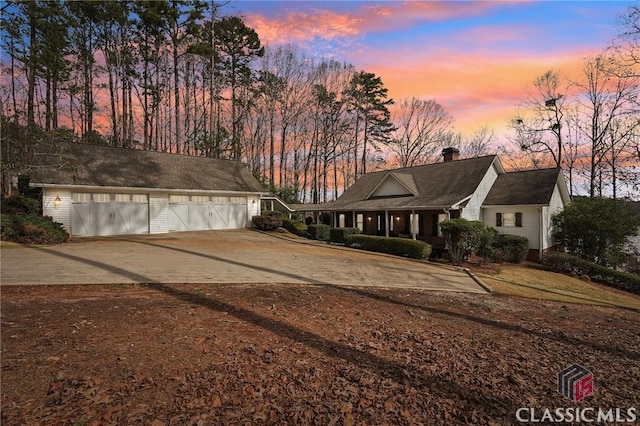 view of front of house with a garage and a chimney