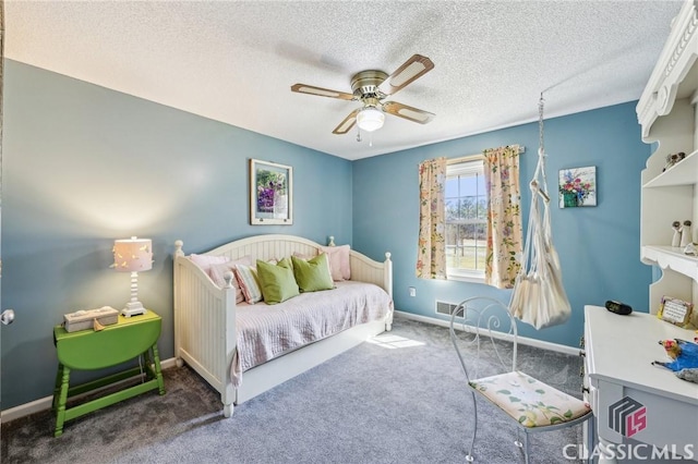 bedroom featuring visible vents, baseboards, ceiling fan, carpet, and a textured ceiling