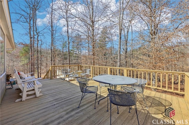 deck featuring outdoor dining area