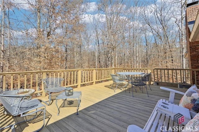 wooden terrace with outdoor dining space