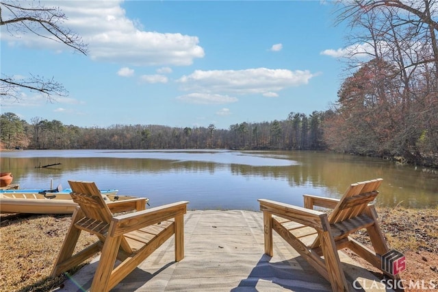 dock area featuring a water view and a forest view