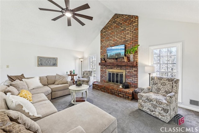 carpeted living room featuring high vaulted ceiling, a fireplace, visible vents, and a wealth of natural light