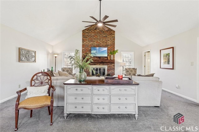 interior space with carpet, a ceiling fan, a brick fireplace, vaulted ceiling, and baseboards