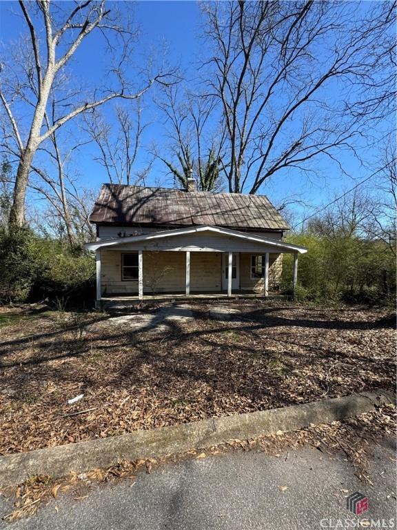 exterior space featuring a porch and a chimney