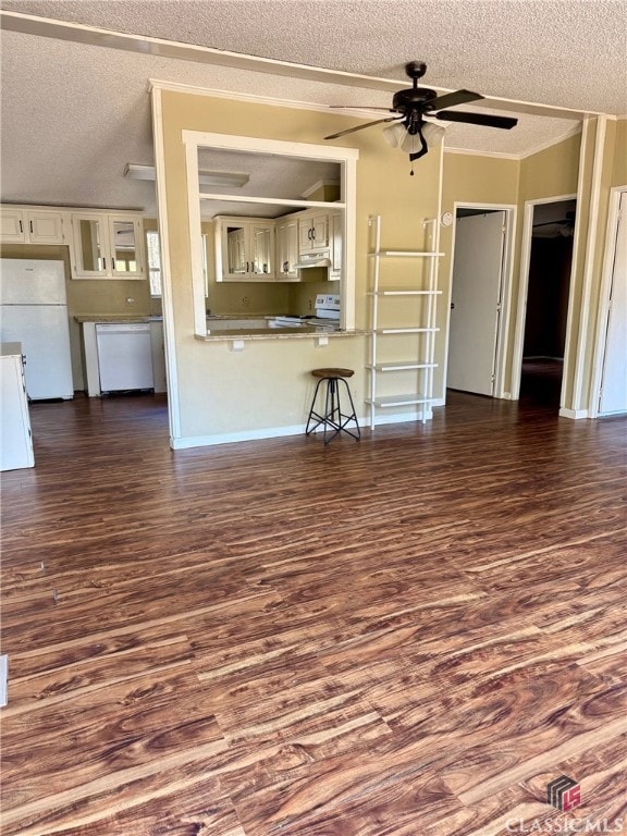 unfurnished living room with ceiling fan, a textured ceiling, dark wood-style flooring, baseboards, and ornamental molding