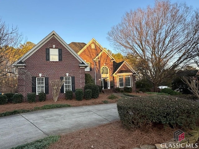 traditional-style house featuring brick siding