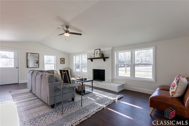 living room featuring baseboards, a ceiling fan, wood finished floors, vaulted ceiling, and a fireplace