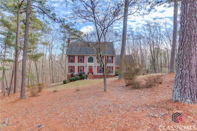 colonial home featuring a chimney