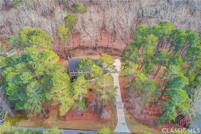 drone / aerial view featuring a wooded view