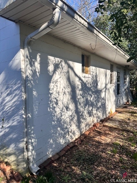 view of home's exterior with concrete block siding