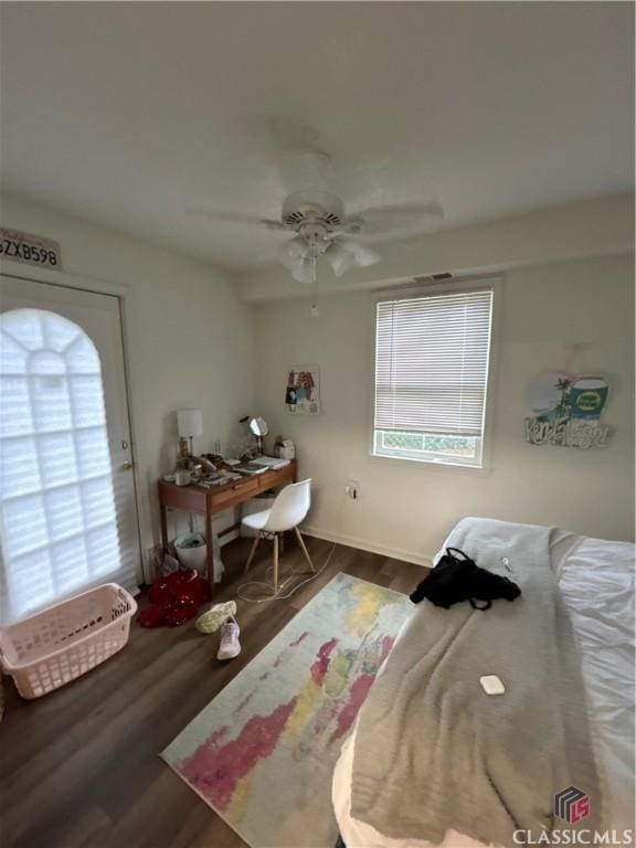 bedroom featuring dark wood-style floors and a ceiling fan