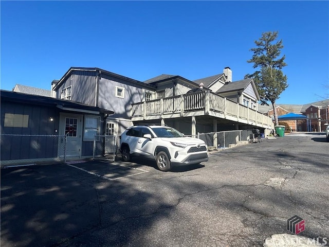 view of building exterior with uncovered parking