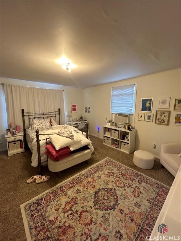 bedroom featuring dark carpet