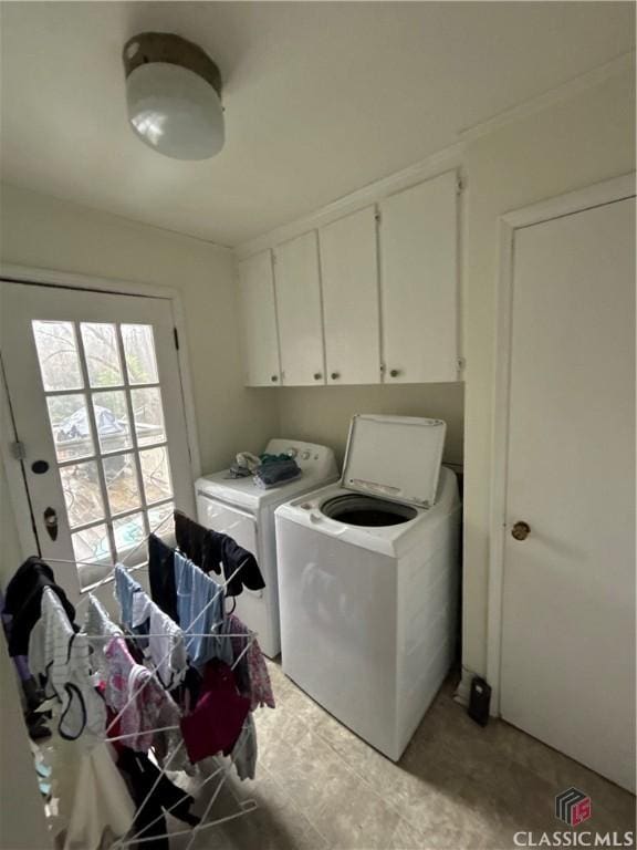 clothes washing area with cabinet space and independent washer and dryer