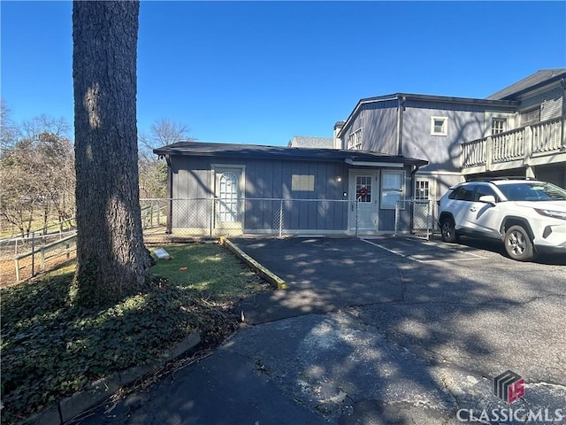 view of side of home featuring fence