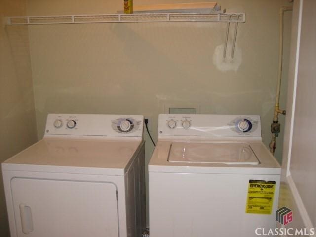 washroom with washing machine and clothes dryer