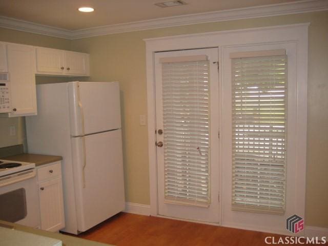 kitchen featuring crown molding, recessed lighting, light wood-style flooring, white cabinets, and white appliances