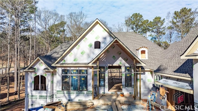 view of front of home featuring roof with shingles