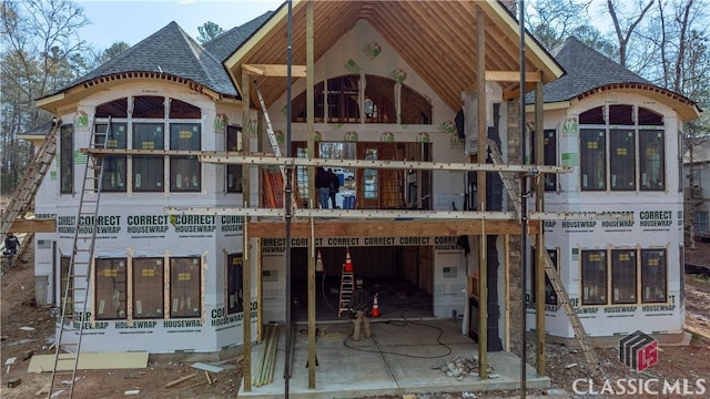 exterior space with roof with shingles