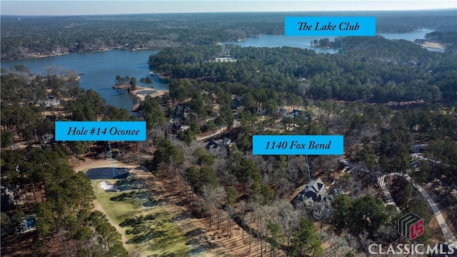 aerial view featuring a water view and a wooded view