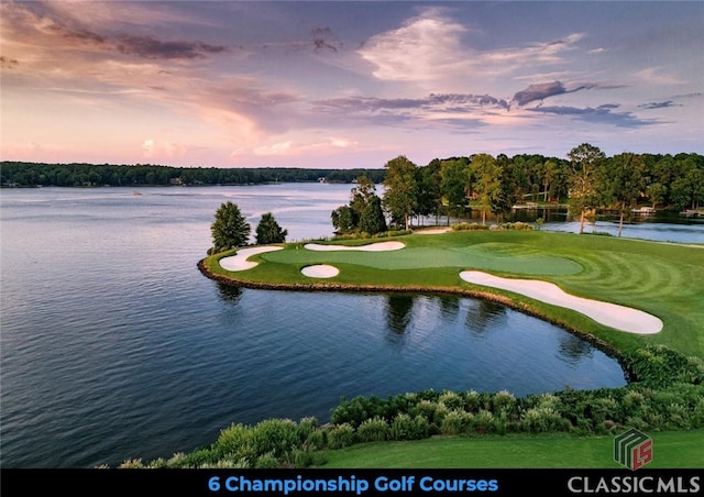 exterior space featuring view of golf course and a water view